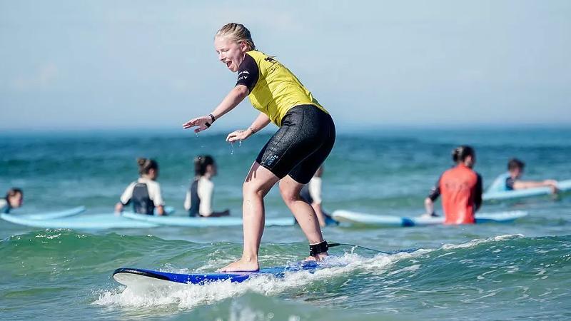 Im Ferienlager ab 12 lernt ein Mädchen surfen