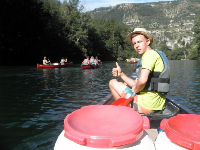 Junge zeigt Daumen hoch auf der Kanutour Frankreich
