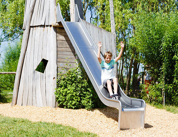 Junge rutscht auf dem Spielplatz im Ferienlager Sonnenhof
