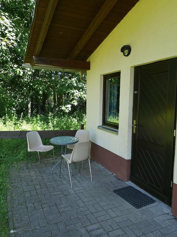 Teilnehmer einer betreuten Kinderreise haben einen Tisch vor dem Haus