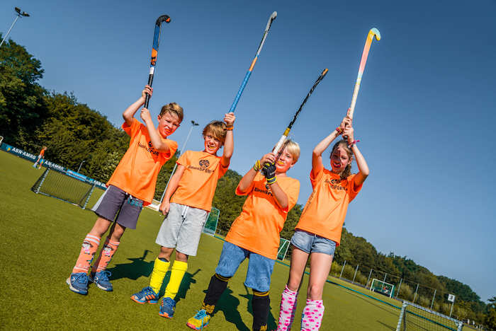 Teilnehmer einer Kinderreise Holland spielen Hockey
