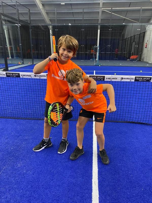 Zwei Jungs des Tennis-Camps umarmen sich