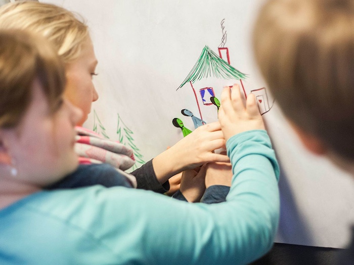 Teilnehmer eines Kinder und Jugendcamps malen Wände an