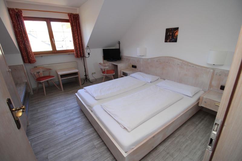 Das Dachzimmer auf Schülersprachreise verfügt über ein Doppelbett und einen Tisch