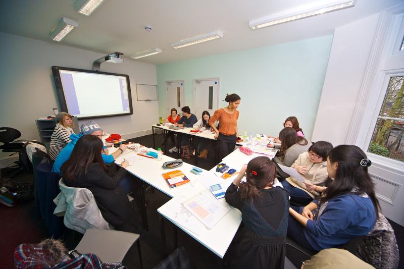 Schülerinnen sitzen im Sprachcamp England in einem Klassenraum zusammen
