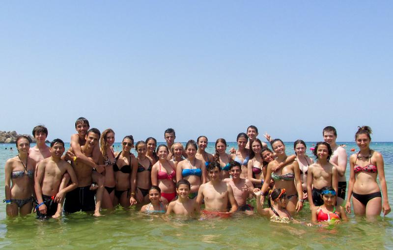 Eine Gruppe von Schülern steht auf Sprachreise Malta Schüler zusammen im Meer