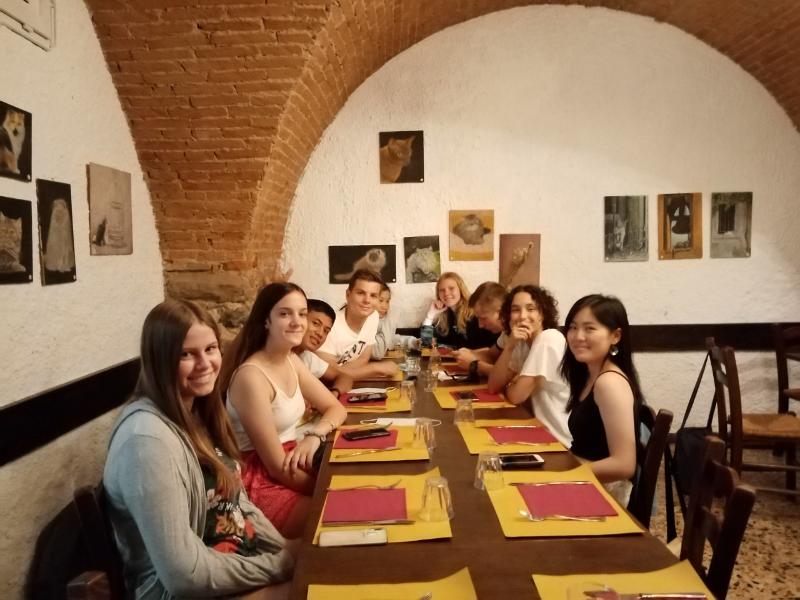 Teilnehmer der Sprachreise Italien sitzen in einem Restaurant am Tisch