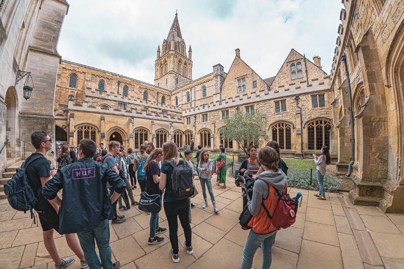 Mehrere Schüler habne sich in einem wunderschönen Innenhof versammelt und verbringen dort ihre Schulpause und lernen sich besser kennen bei den Sprachreisen Weymouth